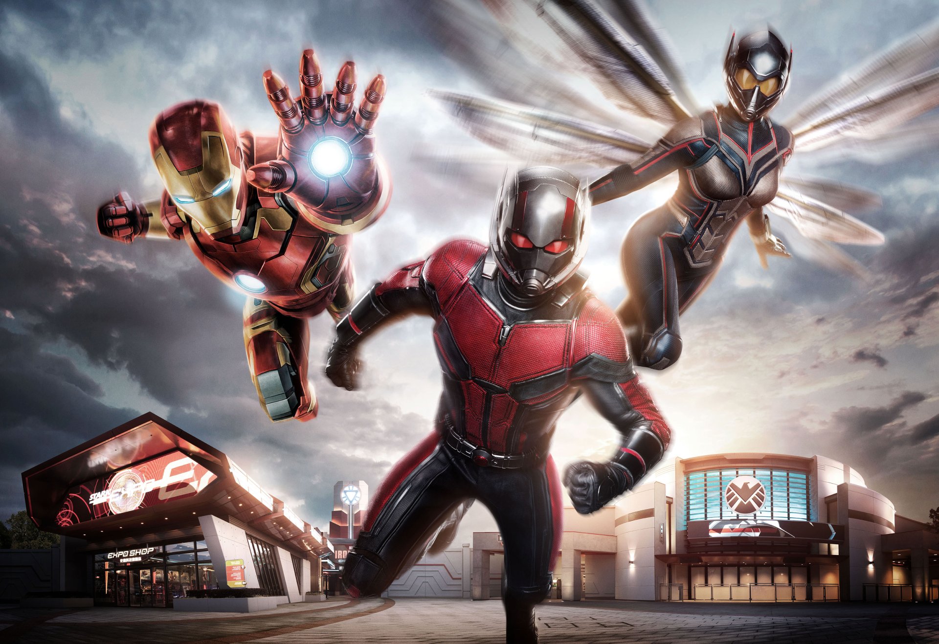 HD PC desktop wallpaper featuring Marvel Studios' Ant-Man, Wasp, and Iron Man in dynamic action poses against a dramatic sky backdrop.