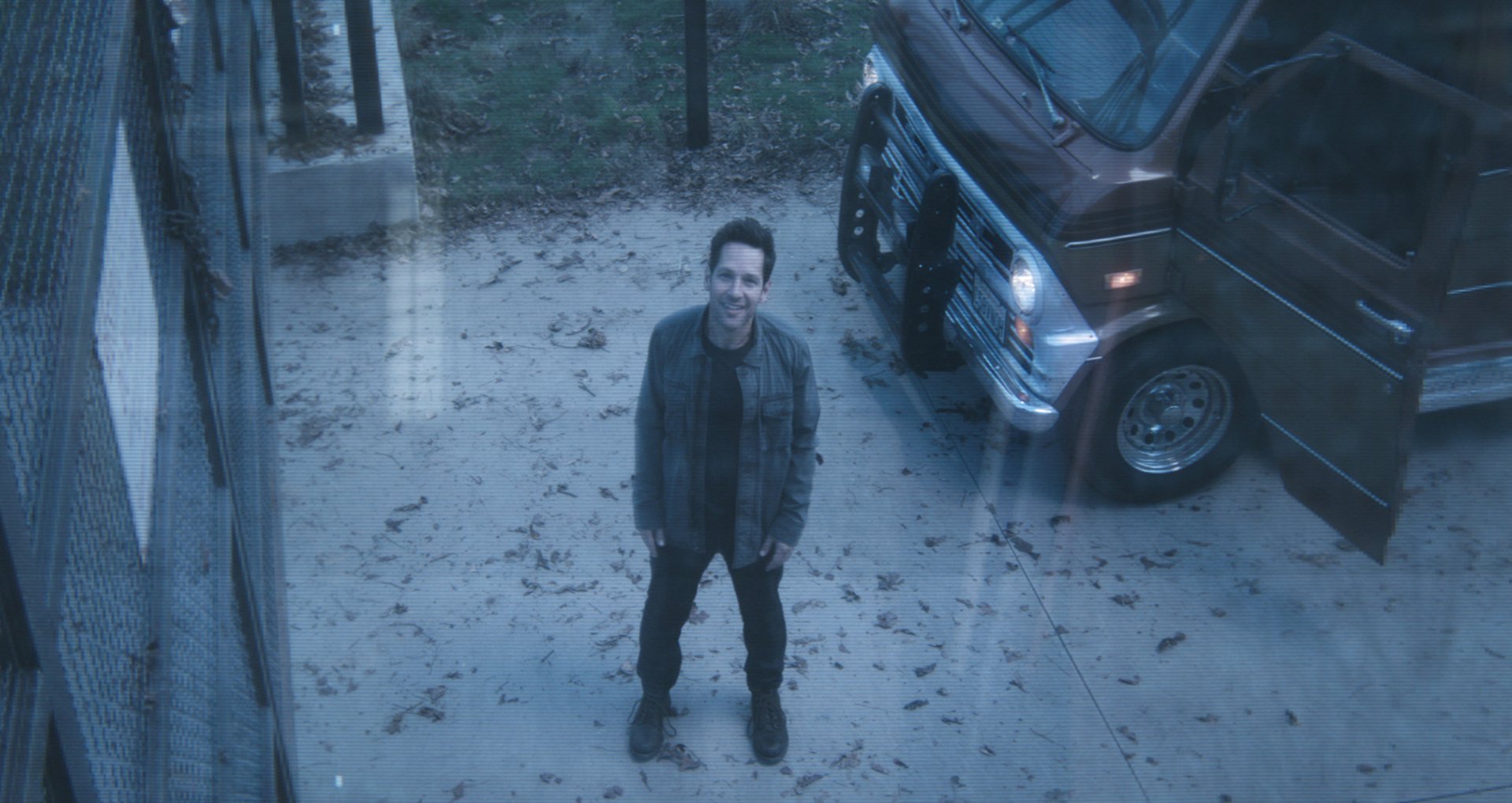 HD desktop wallpaper featuring Paul Rudd as Ant-Man from Avengers Endgame, standing outside next to a van.