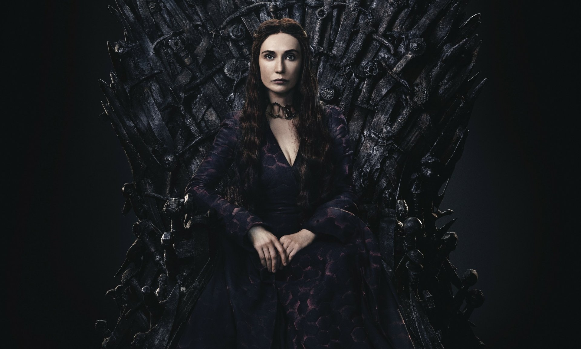 Melisandre (Game of Thrones) seated on the Iron Throne in dark robes, hands folded — 2K Quad HD PC desktop wallpaper/background.
