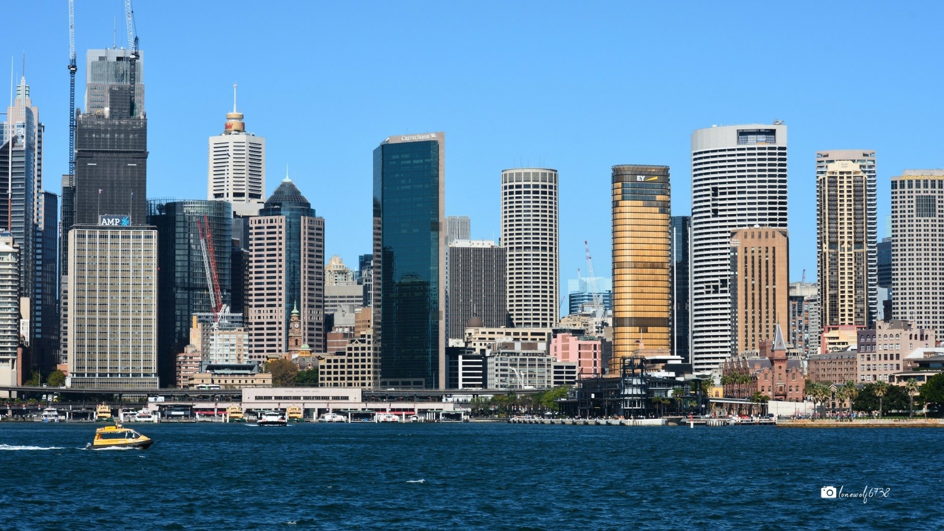 2K Quad HD desktop wallpaper of Sydney skyline: man-made skyscrapers and waterfront along Sydney Harbour, Australia.