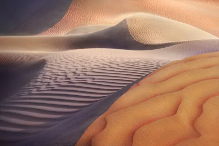 HD PC desktop wallpaper showcasing smooth sand dunes in a desert landscape with natural patterns and warm lighting.