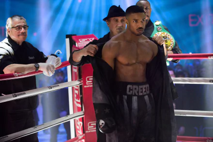 HD wallpaper of Michael B. Jordan as Adonis Creed with Sylvester Stallone as Rocky Balboa in the background from Creed II.