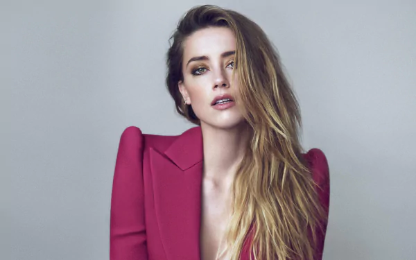 High-resolution 4K Ultra HD PC wallpaper featuring blonde celebrity Amber Heard in a bold red blazer against a neutral background.