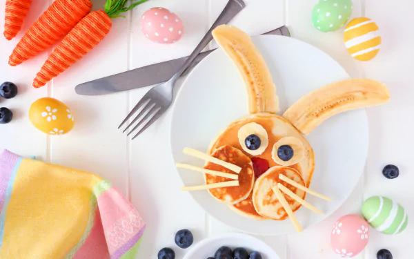 5K Ultra HD PC desktop wallpaper: bunny-shaped pancake breakfast still life with carrot props, colorful Easter eggs, blueberries and cutlery on a white plate.