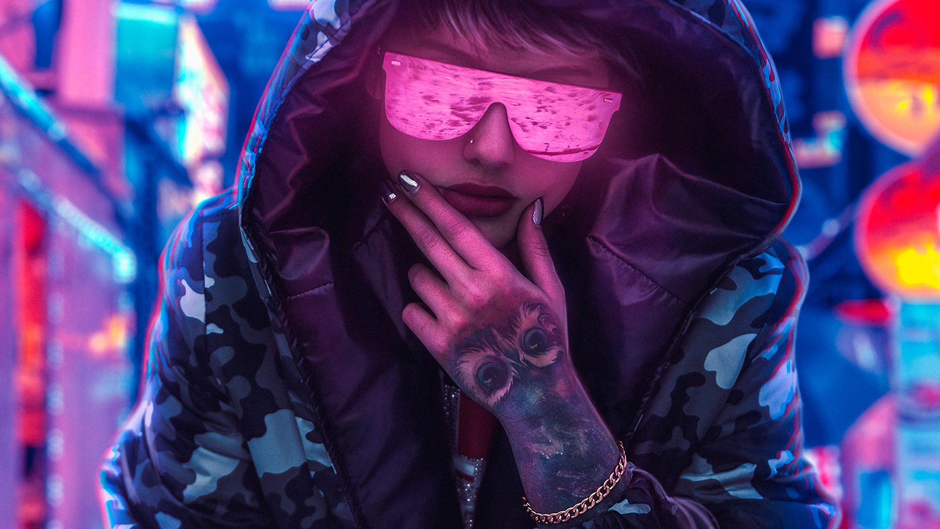 A cyberpunk-themed HD wallpaper depicting a person in a hood, sporting reflective sunglasses and lipstick, with a tattoo on the hand, set against a neon-lit urban backdrop.