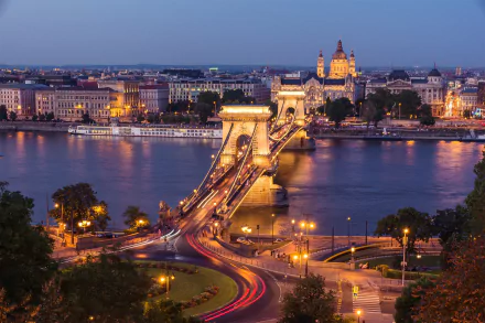 Time-lapse view of the illuminated Chain Bridge spanning the Danube River in Budapest, Hungary, captured as a striking HD desktop wallpaper.