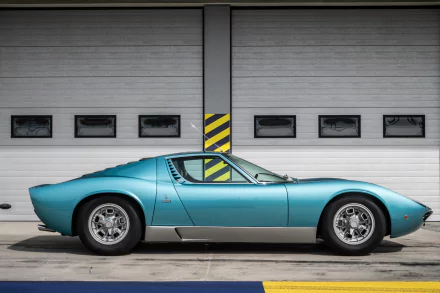 A turquoise Lamborghini Miura supercar parked in front of a modern garage door, featured as a 4K Ultra HD PC desktop wallpaper and background.