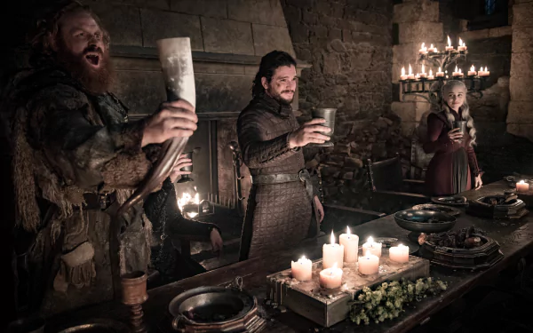 Game of Thrones TV wallpaper: Tormund Giantsbane, Jon Snow and Daenerys Targaryen cheer with cups at a candlelit feast.