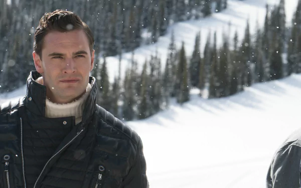 HD desktop wallpaper from Cold Pursuit featuring a man in winter clothing with snowy mountains in the background.