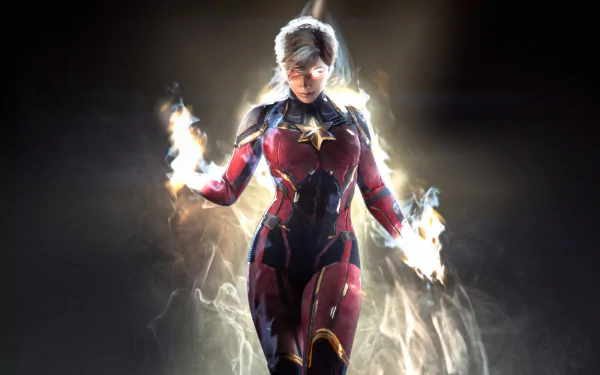 Comic Captain Marvel in a glowing red-and-blue suit, energy flames in her hands as she hovers over a smoky dark backdrop — 4K Ultra HD PC desktop wallpaper/background.