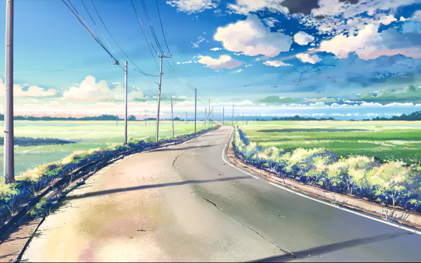 HD anime landscape wallpaper from 5 Centimeters per Second featuring a serene road winding through green fields under a vibrant, cloud-filled sky.