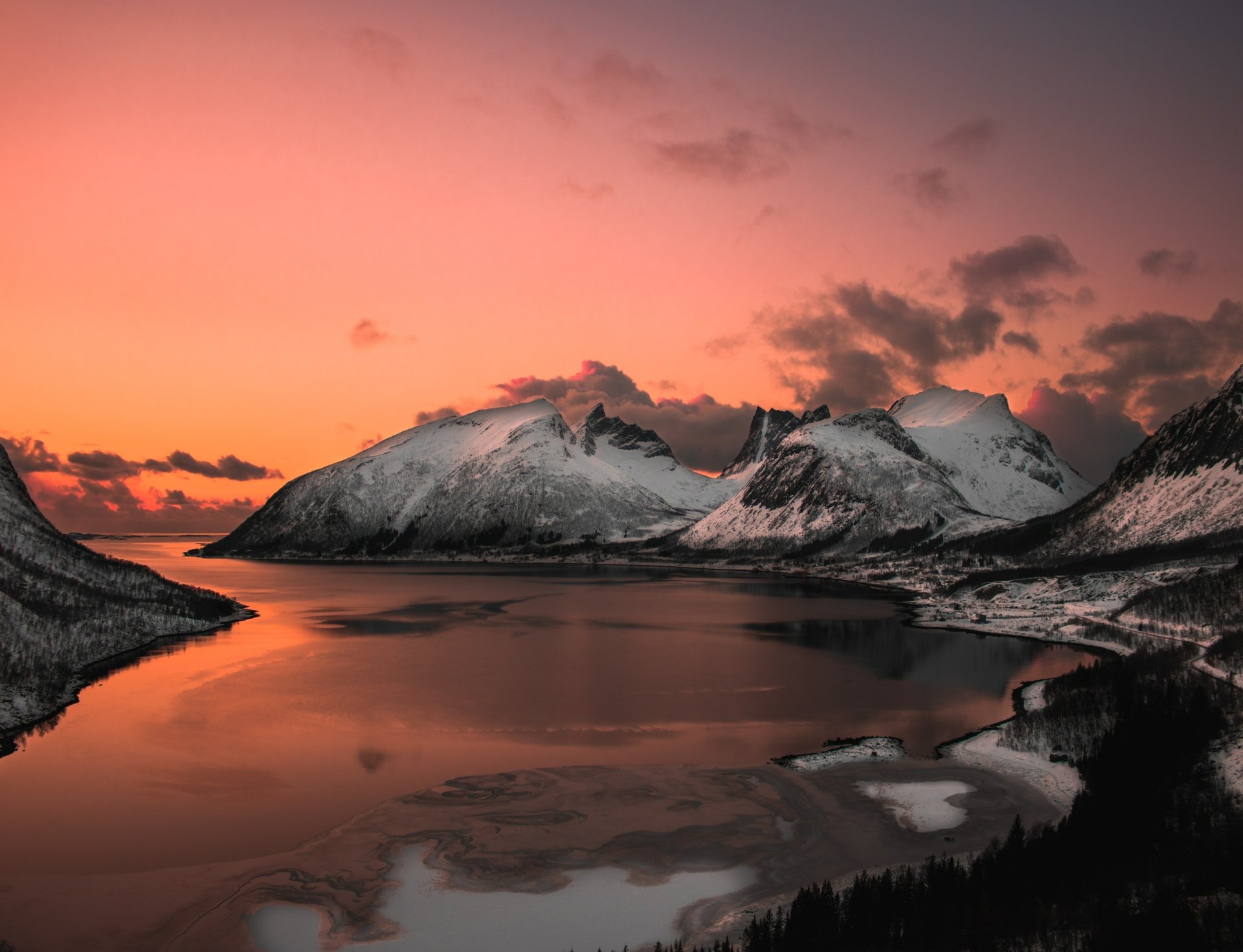 Snow-covered mountain range reflected in a calm lake at sunset, showcasing striking natural beauty in a 4K Ultra HD desktop wallpaper.