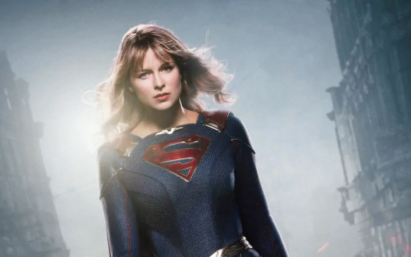 4K Ultra HD wallpaper featuring Melissa Benoist as Kara Zor-El/Kara Danvers in her Supergirl costume, set against a dramatic, misty urban backdrop.