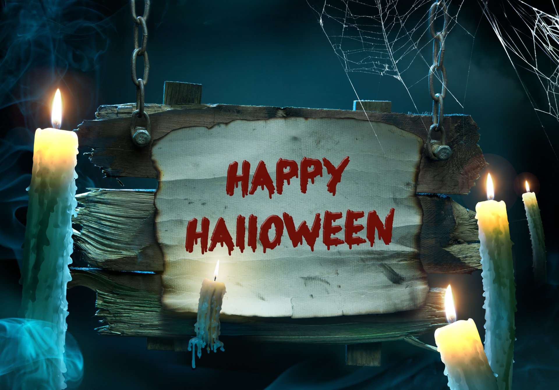 4K Ultra HD PC desktop wallpaper: eerie Halloween holiday scene with dripping candles and cobwebs framing a weathered wooden sign that reads HAPPY HALLOWEEN.