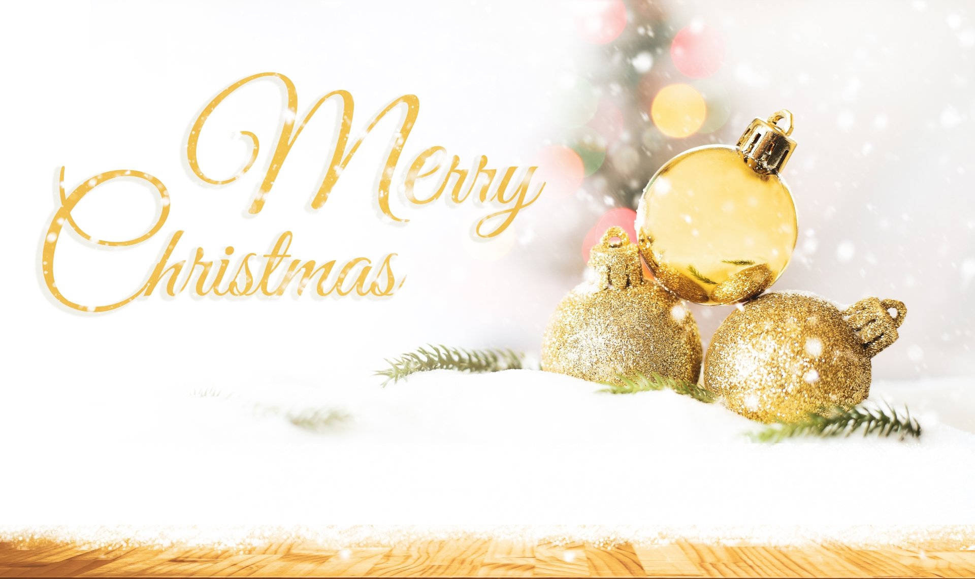 A festive 4K Ultra HD Christmas desktop wallpaper featuring golden holiday ornaments on snow with Merry Christmas in elegant gold script.