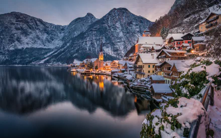 Winter view of the man-made town of Hallstatt, Austria, nestled between a lake and snow-covered mountains, captured in stunning 4K Ultra HD resolution.