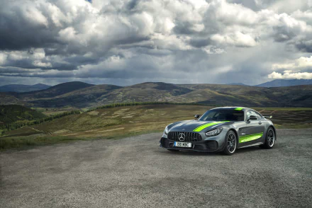 Silver Mercedes‑AMG GT R supercar on a remote mountain road under dramatic clouds — a 4K Ultra HD PC desktop wallpaper of a Mercedes‑Benz performance vehicle.