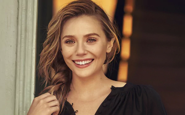 HD PC desktop wallpaper featuring a smiling Elizabeth Olsen with loose hair, wearing a black top against a softly lit background.