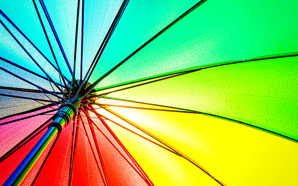 Photograph of a rainbow umbrella canopy in vivid colors, radiating spokes — 4K Ultra HD PC desktop wallpaper and background.