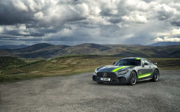 Silver Mercedes‑AMG GT R supercar on a remote mountain road under dramatic clouds — a 4K Ultra HD PC desktop wallpaper of a Mercedes‑Benz performance vehicle.