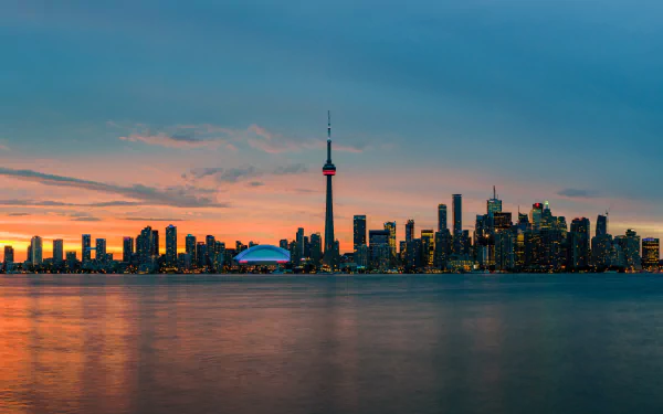 Toronto city skyline at dusk featuring skyscrapers and the CN Tower under a vibrant sky, captured in stunning 8K Ultra HD resolution.