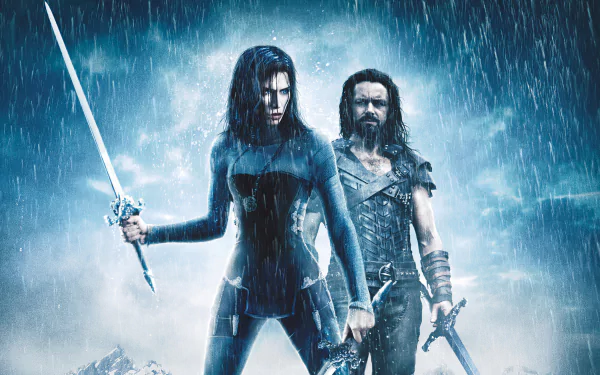 Kate Beckinsale and a male character stand in the rain wielding swords in a dramatic 4K Ultra HD wallpaper from the movie Underworld: Rise of the Lycans.