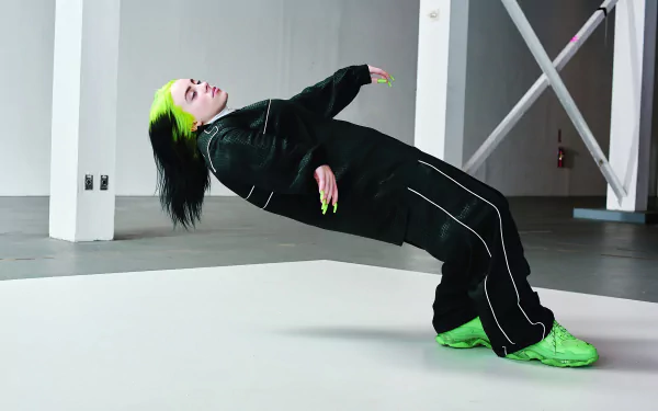 4K Ultra HD wallpaper featuring American singer Billie Eilish in a dynamic pose, showcasing her signature green and black style against a minimalist industrial backdrop.
