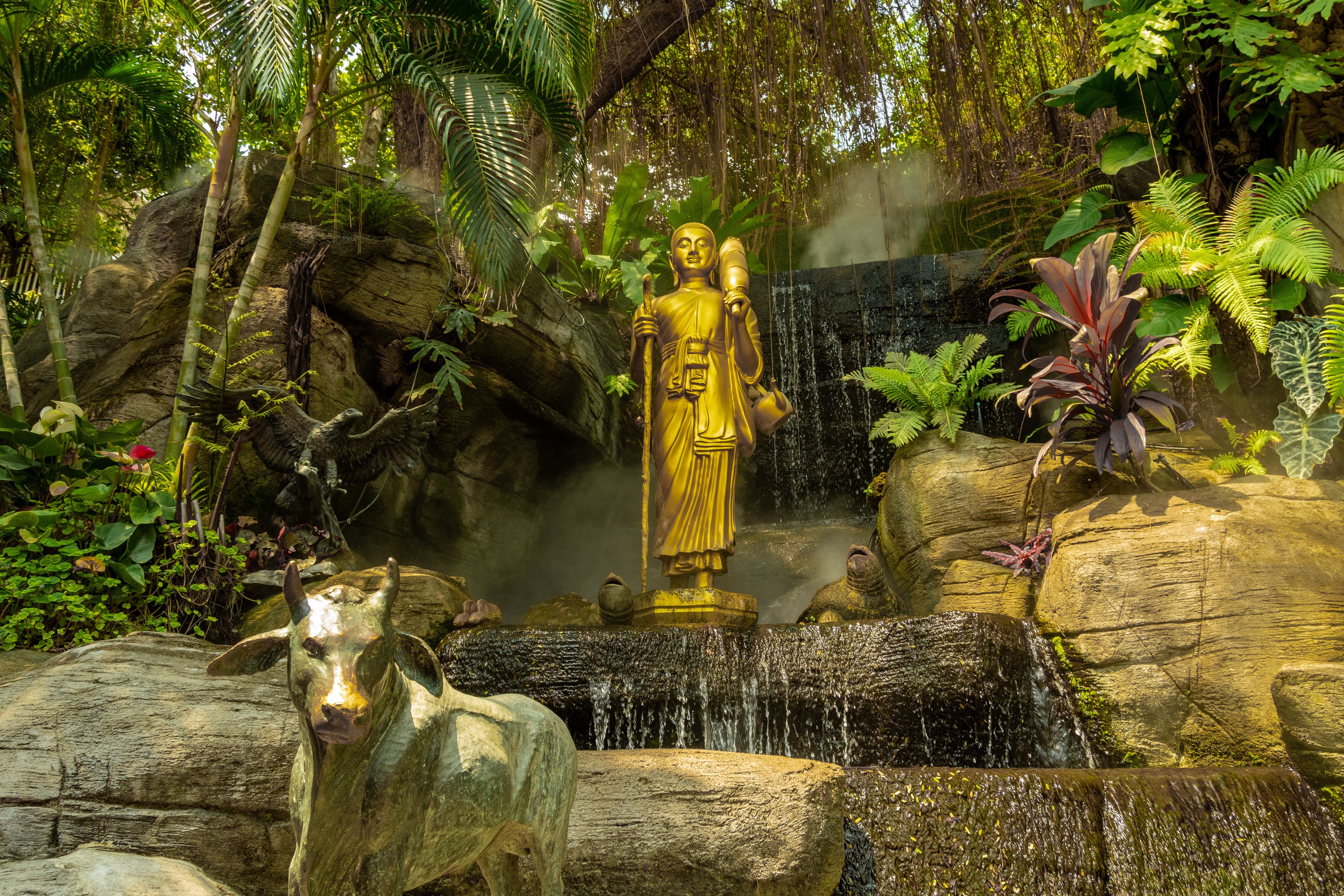 Statues and Waterfall in a Garden surrounded by Ferns by kmarius