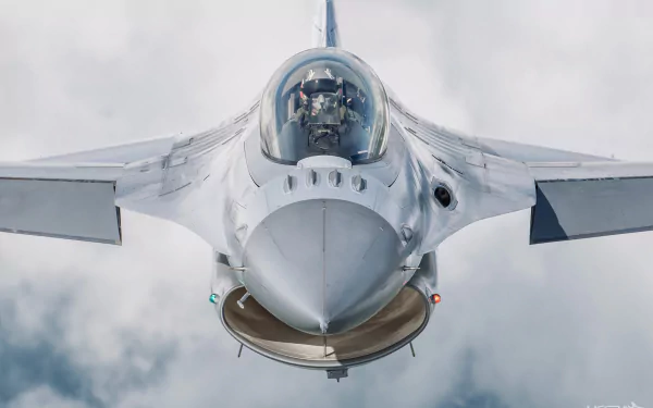 Front view of a General Dynamics F-16 Fighting Falcon jet fighter piloted in flight, captured in high-definition military aircraft wallpaper style.