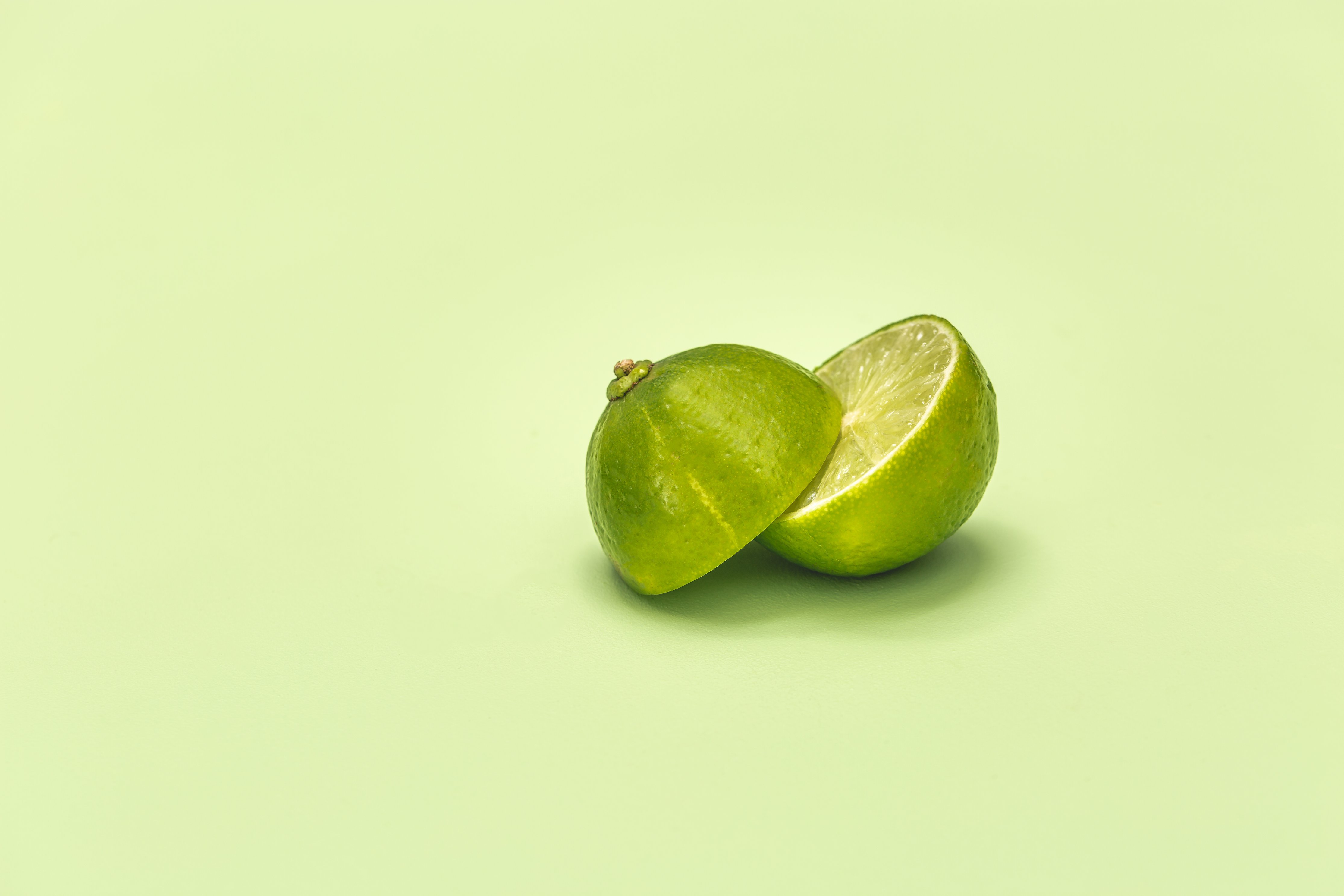 Lime Cut In Half On Green Surface by Matthew Henry