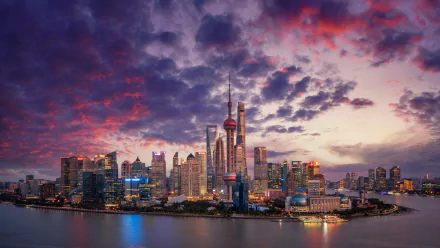 4K Ultra HD cityscape of Shanghai showcasing the skyline with the iconic Oriental Pearl Tower and surrounding skyscrapers under a dramatic colorful sky at dusk.
