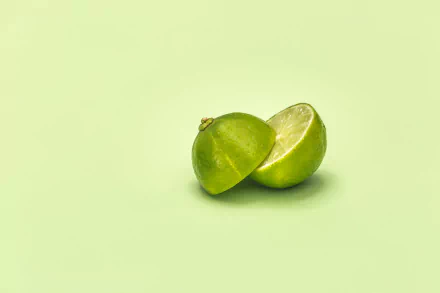  Lime Cut In Half On Green Surface by Matthew Henry