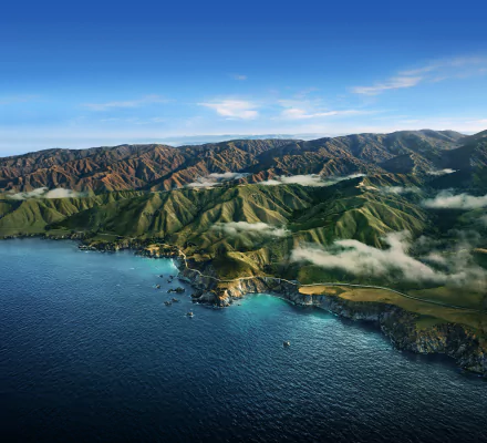 Aerial 4K Ultra HD view of Big Sur coastline with mountains, clouds, ocean, and natural landscape, associated with Apple Inc. desktop wallpaper and background.