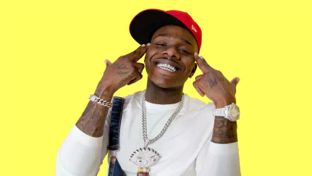 HD desktop wallpaper featuring a smiling person wearing a red cap and white shirt against a vibrant yellow background.