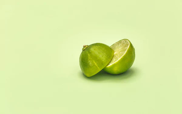  Lime Cut In Half On Green Surface by Matthew Henry