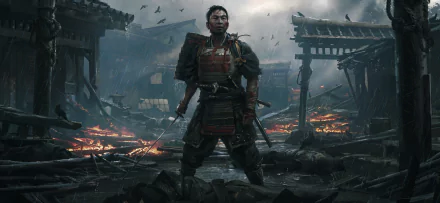 Jin Sakai stands amid a burning village in this HD PC desktop wallpaper from the video game Ghost of Tsushima, capturing the game's intense and atmospheric setting.