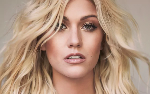 Close-up HD portrait of blonde actress Katherine McNamara with natural makeup, featuring her face as a striking PC desktop wallpaper background.