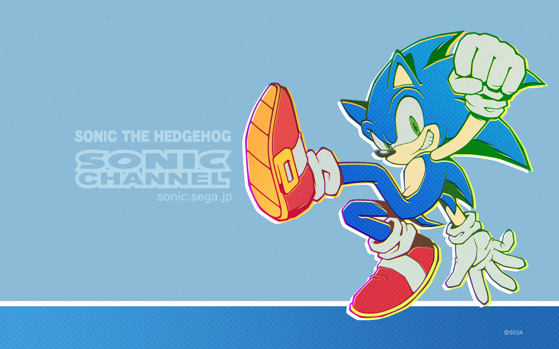 Sonic the Hedgehog grinning with green eyes, mid-jump showing red sneakers on a blue HD PC desktop wallpaper featuring the Sonic Channel logo — video game background.