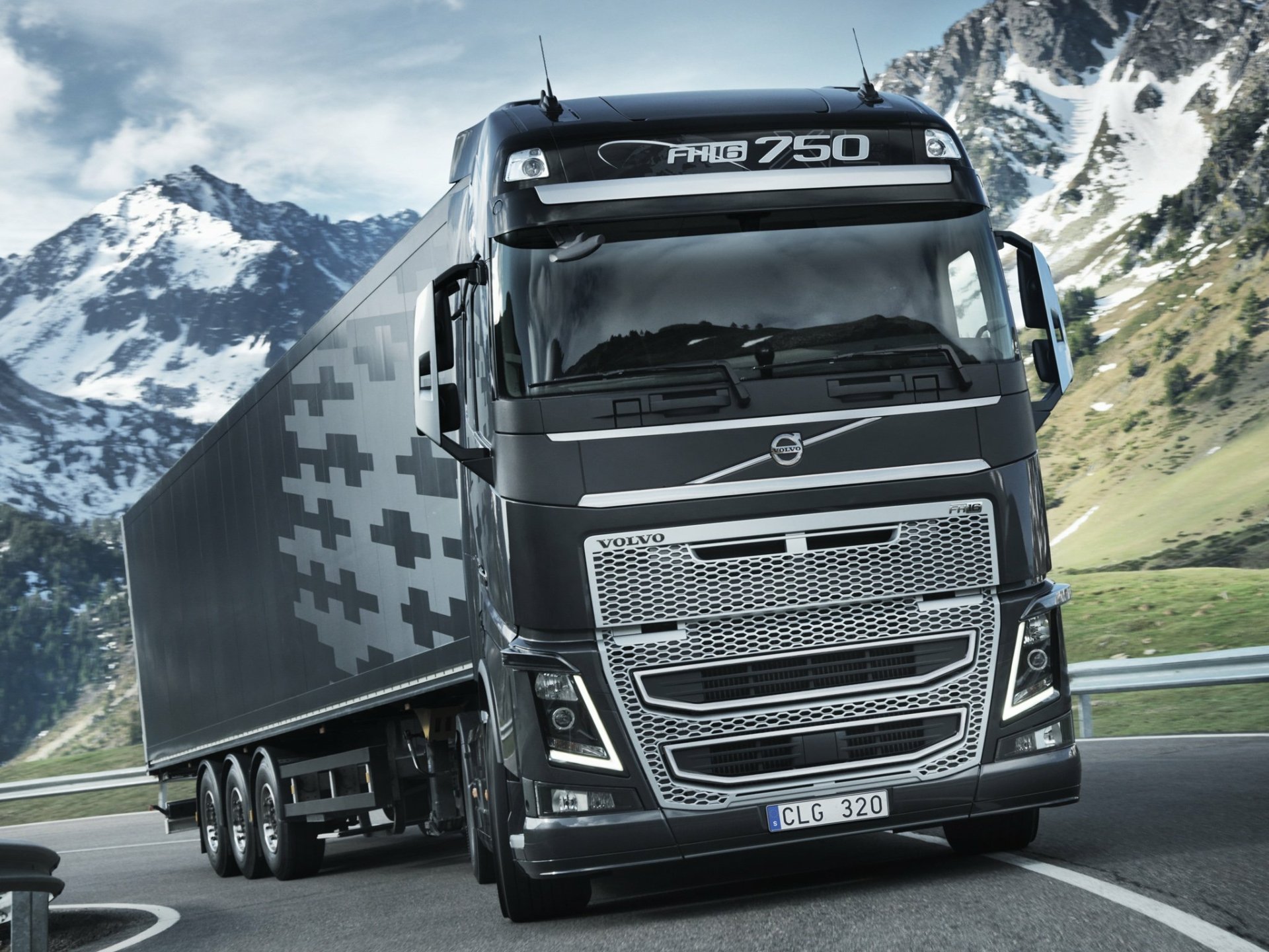HD desktop wallpaper featuring a Volvo FH16 750 truck traversing a mountainous landscape.