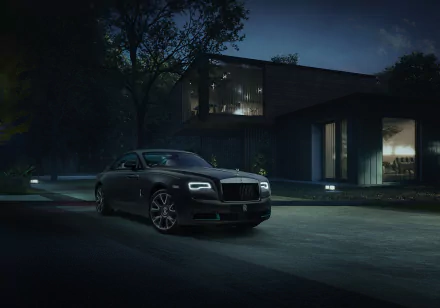 A sleek black Rolls-Royce Wraith parked in front of a modern house at night, captured in stunning 4K Ultra HD as a desktop wallpaper and background.