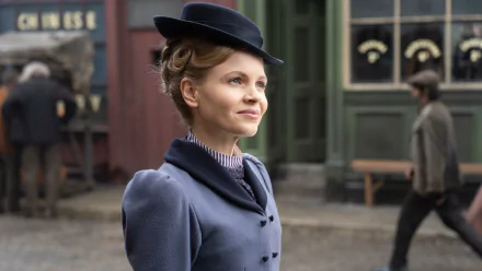 HD desktop wallpaper of Miss Scarlet from Miss Scarlet and the Duke in period attire with a cobblestone street backdrop.