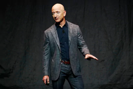 HD wallpaper of a man in a blazer presenting on stage, offering a professional and motivational backdrop.