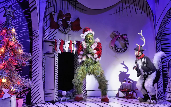 HD wallpaper from Dr. Seuss' The Grinch Musical showing the Grinch and a dog character in a festive, cartoon-style room.