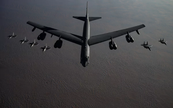 A 4K Ultra HD wallpaper featuring a Boeing B-52 Stratofortress bomber flanked by McDonnell Douglas F-15 Eagles and General Dynamics F-16 Fighting Falcons in flight.
