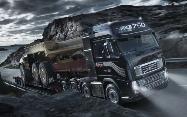 HD desktop wallpaper of a Volvo FH16 750 truck driving on a mountain road.