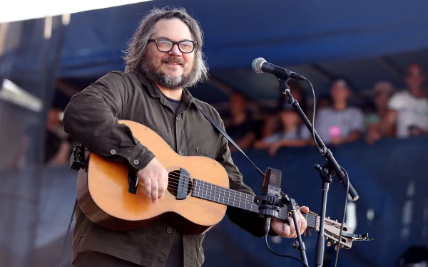 HD desktop wallpaper featuring a musician with a guitar preparing to perform, encapsulating a serene concert vibe.