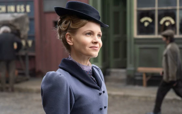 HD desktop wallpaper of Miss Scarlet from Miss Scarlet and the Duke in period attire with a cobblestone street backdrop.