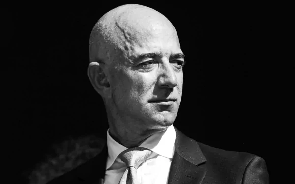 HD desktop wallpaper featuring a black and white portrait of a bald man in a suit, tagged with Jeff Bezos.