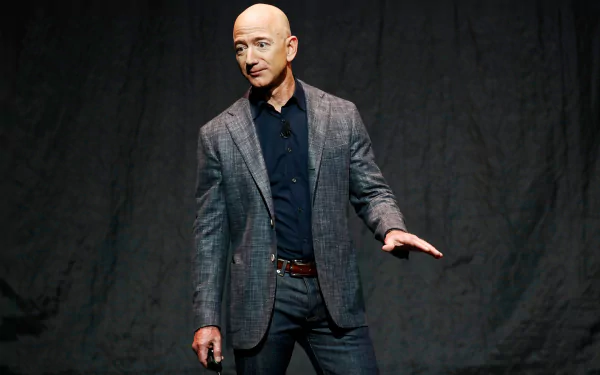 HD wallpaper of a man in a blazer presenting on stage, offering a professional and motivational backdrop.