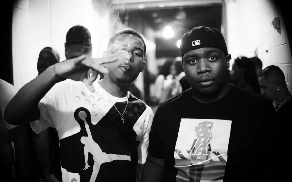 HD desktop wallpaper featuring a black and white photo of two men, one making a hand gesture, tagged with Pooh Shiesty.